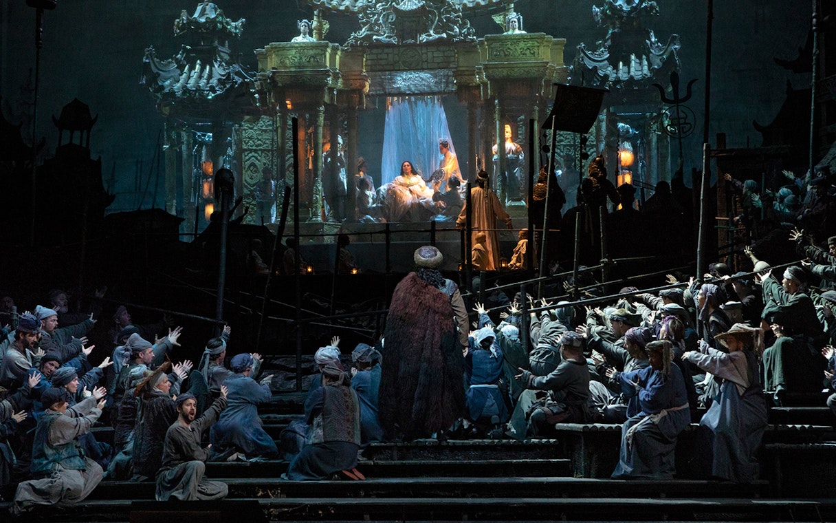 Opera performance of Turandot with elaborate stage set and performers in traditional costumes.