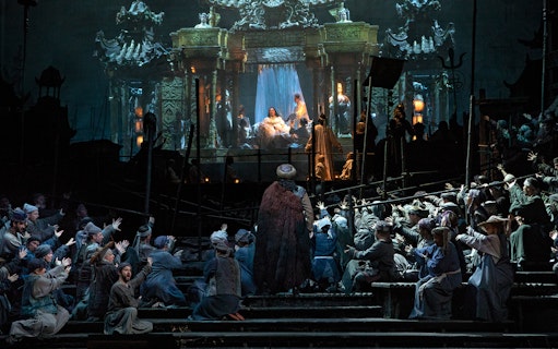 Opera performance of Turandot with elaborate stage set and performers in traditional costumes.