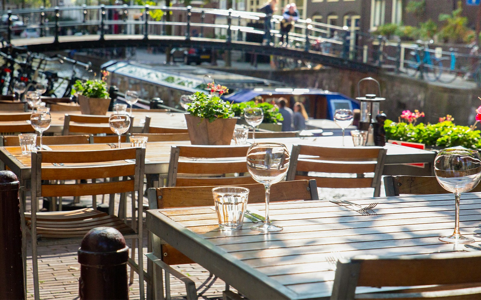 Outdoor dining tables set at a cafe in Amsterdam.