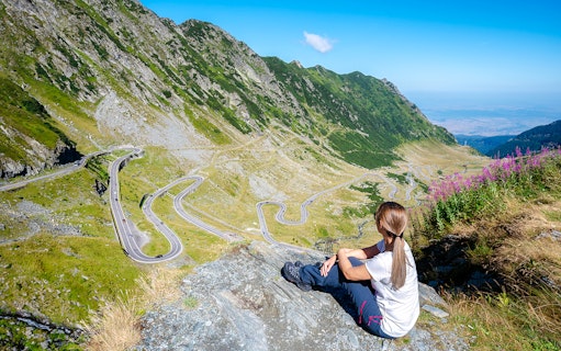 Woman overlooking the winding Transfagarasan Highway in Romania.