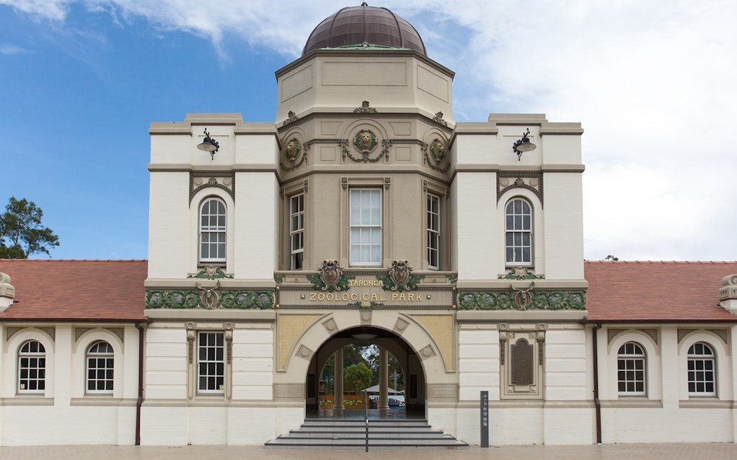 Entrance to Taronga Zoo in Sydney, featuring historic architecture and arched doorway.