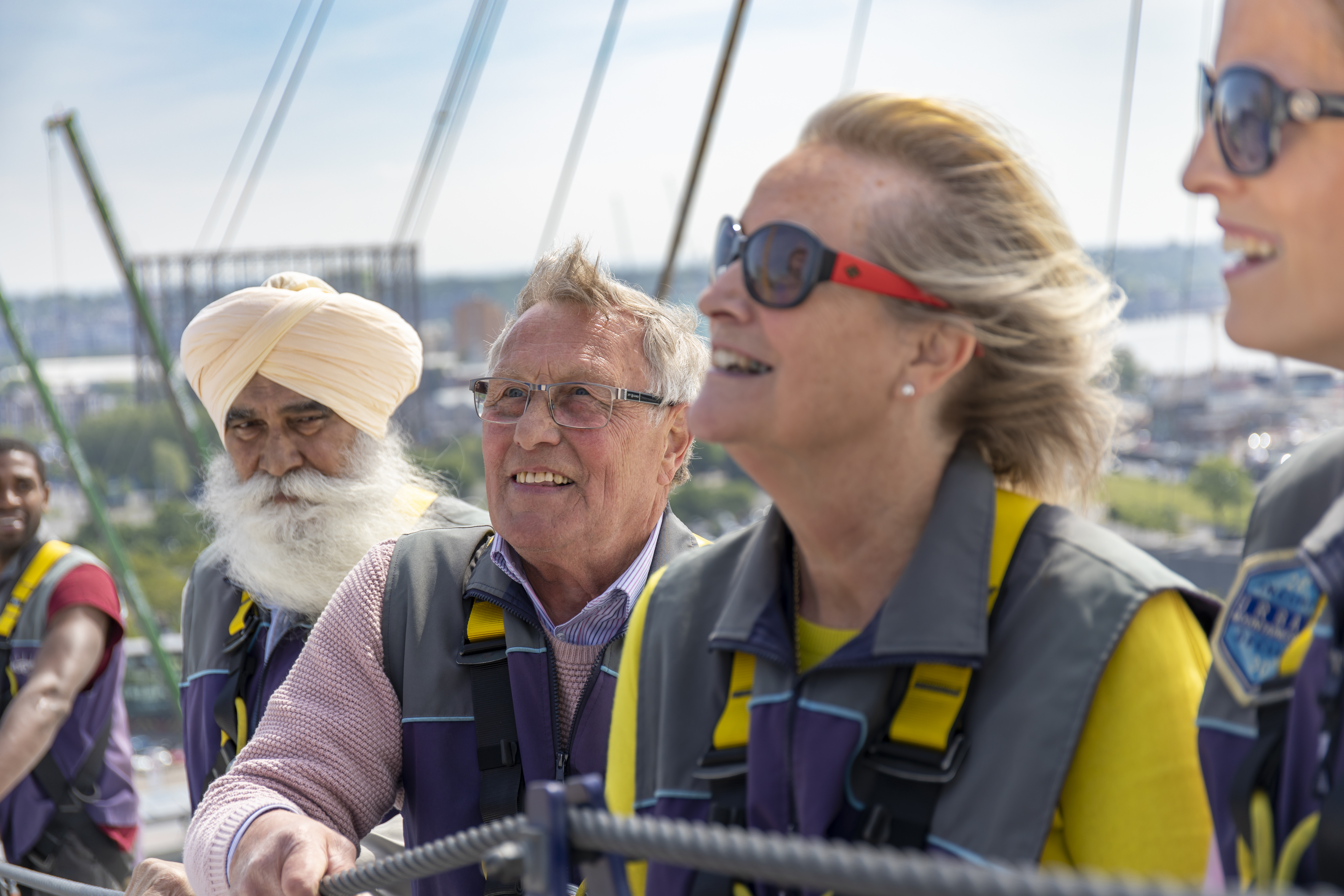 Visitors enjoying a climb at the O2 in London during daytime.