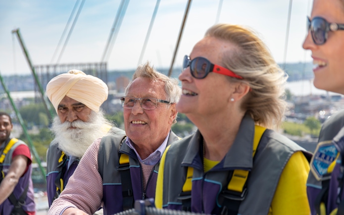 Visitors enjoying a climb at the O2 in London during daytime.