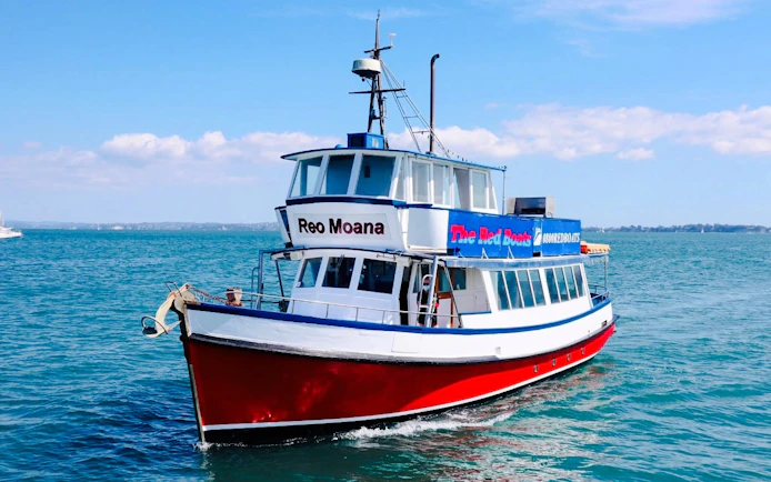 Harbour cruise boat on scenic wine and cheese tour in blue waters.