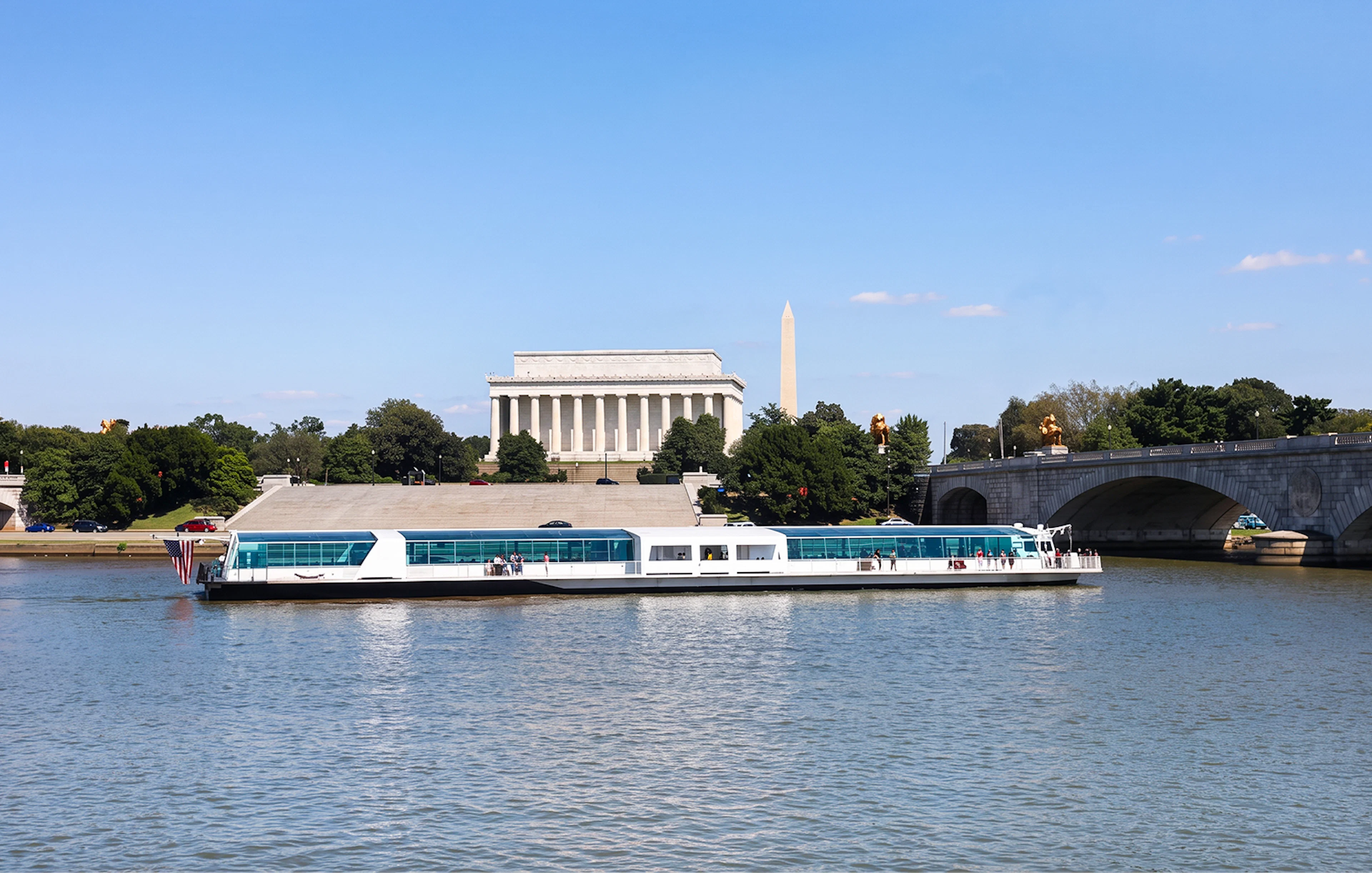 Cruise boat on the Potomac River with Lincoln Memorial and Washington Monument in the background.
