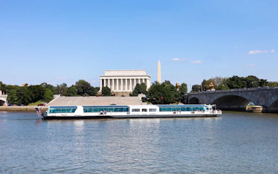 Cruise boat on the Potomac River with Lincoln Memorial and Washington Monument in the background.