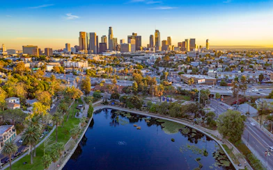 Downtown Los Angeles skyline with high-rise buildings and urban landscape at sunset.