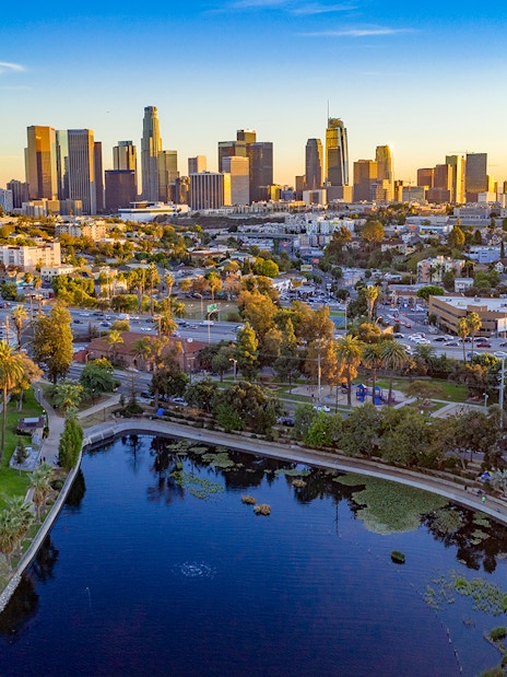 Downtown Los Angeles skyline with high-rise buildings and urban landscape at sunset.