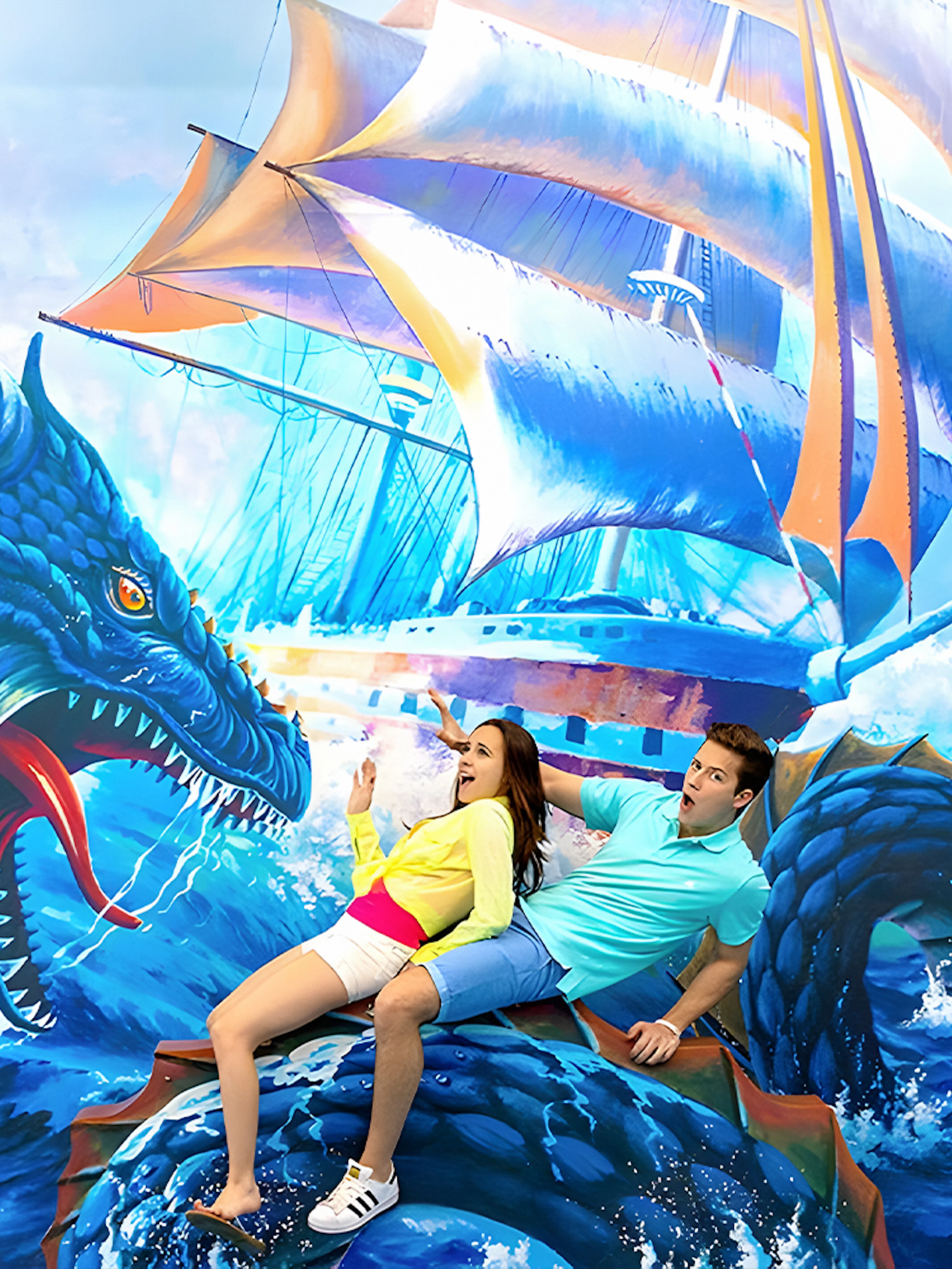 Couple posing with sea dragon mural at Aquaria Phuket.