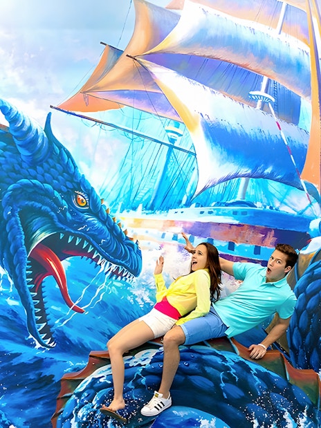Couple posing with sea dragon mural at Aquaria Phuket.