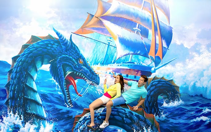 Couple posing with sea dragon mural at Aquaria Phuket.