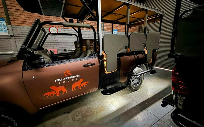 Jeep prepared for Kruger Park safari drive with open seating for wildlife viewing.