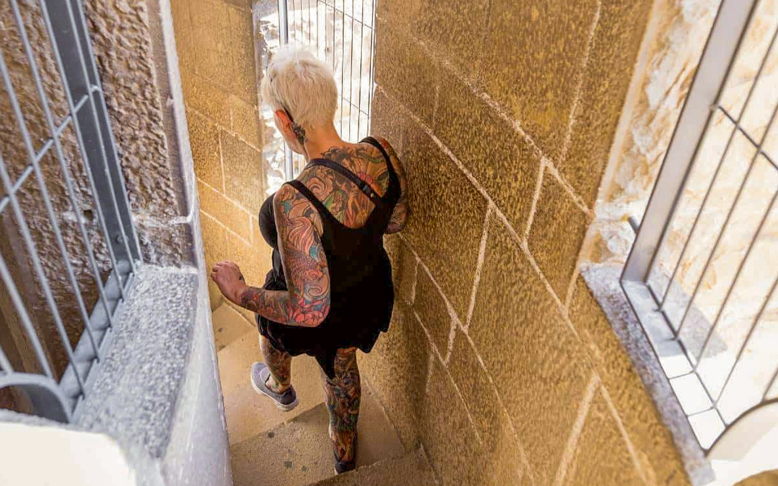 Women descending spiral staircase inside Sagrada Familia tower, Barcelona.