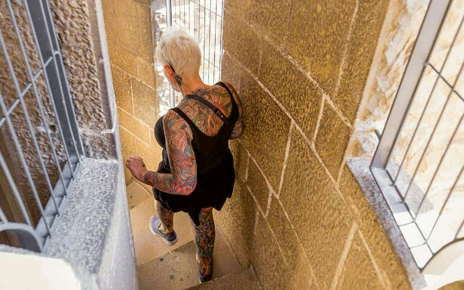 Women descending spiral staircase inside Sagrada Familia tower, Barcelona.