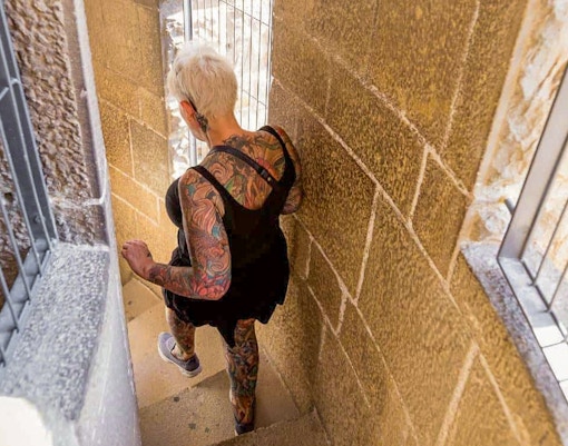 Women descending spiral staircase inside Sagrada Familia tower, Barcelona.