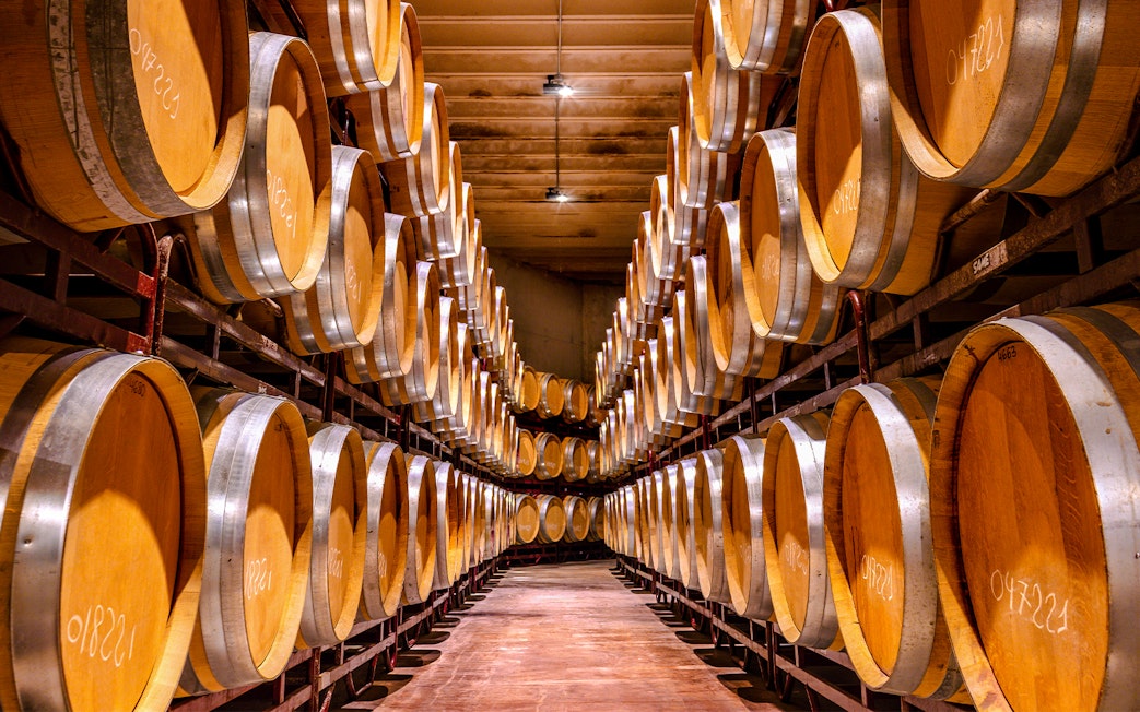 Barrels aging whiskey in a distillery cellar.