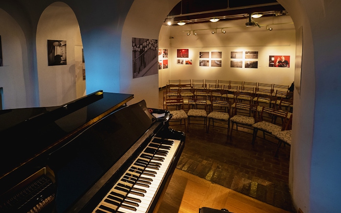 Piano and seating area for Chopin recital in Old Town venue.