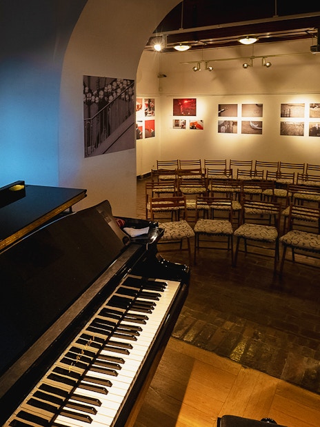 Piano and seating area for Chopin recital in Old Town venue.