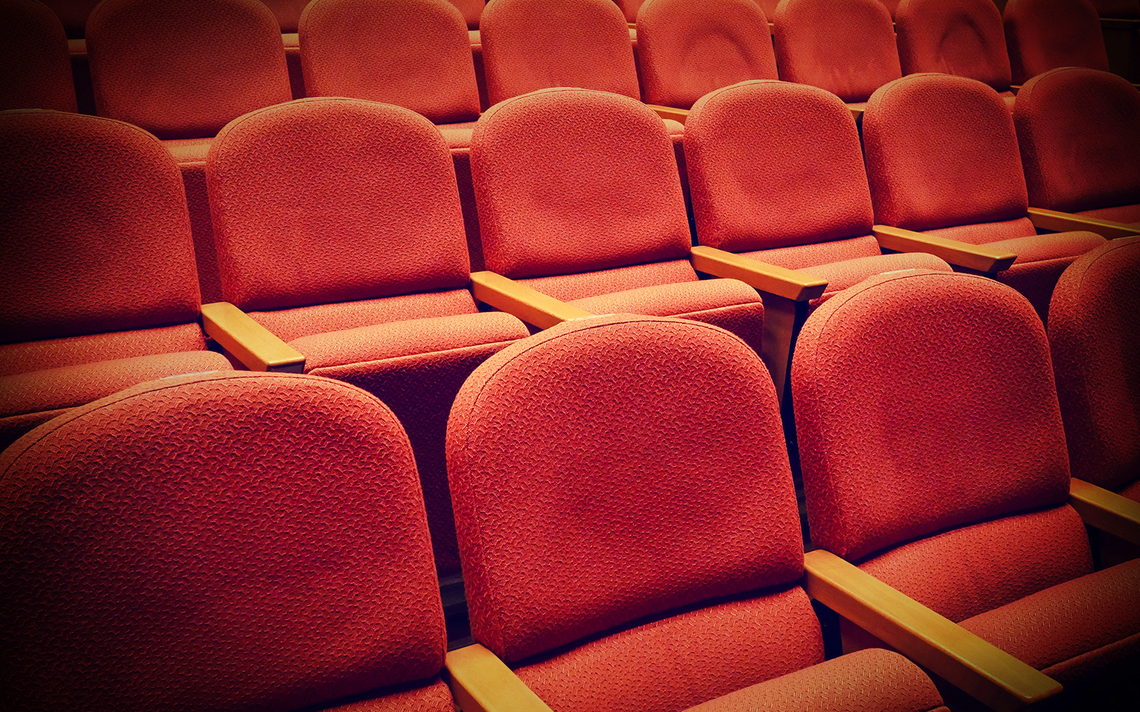 Rows of red seats in the Lords Chamber at Houses of Parliament.