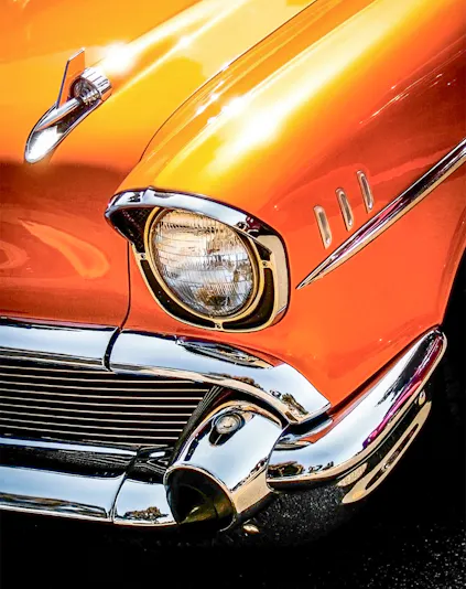 Classic orange car front detail at Malta Classic Car Collection.