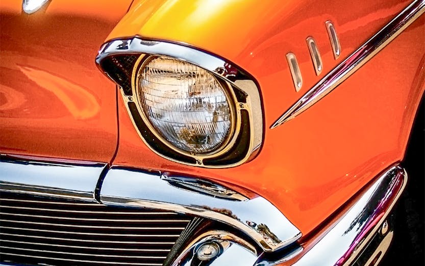 Classic orange car front detail at Malta Classic Car Collection.