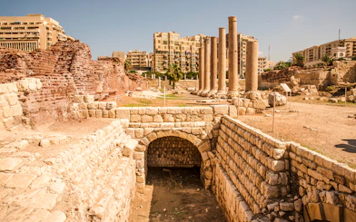 Roman ruins with columns and ancient stone structures in Cairo, Egypt.