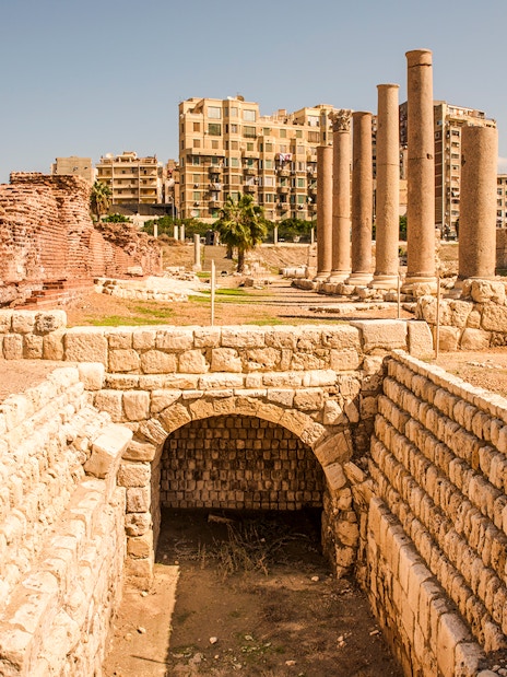 Roman ruins with columns and ancient stone structures in Cairo, Egypt.