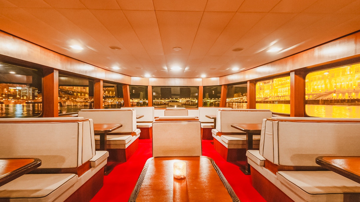 Budapest Danube River cruise interior with passengers enjoying nighttime city views.