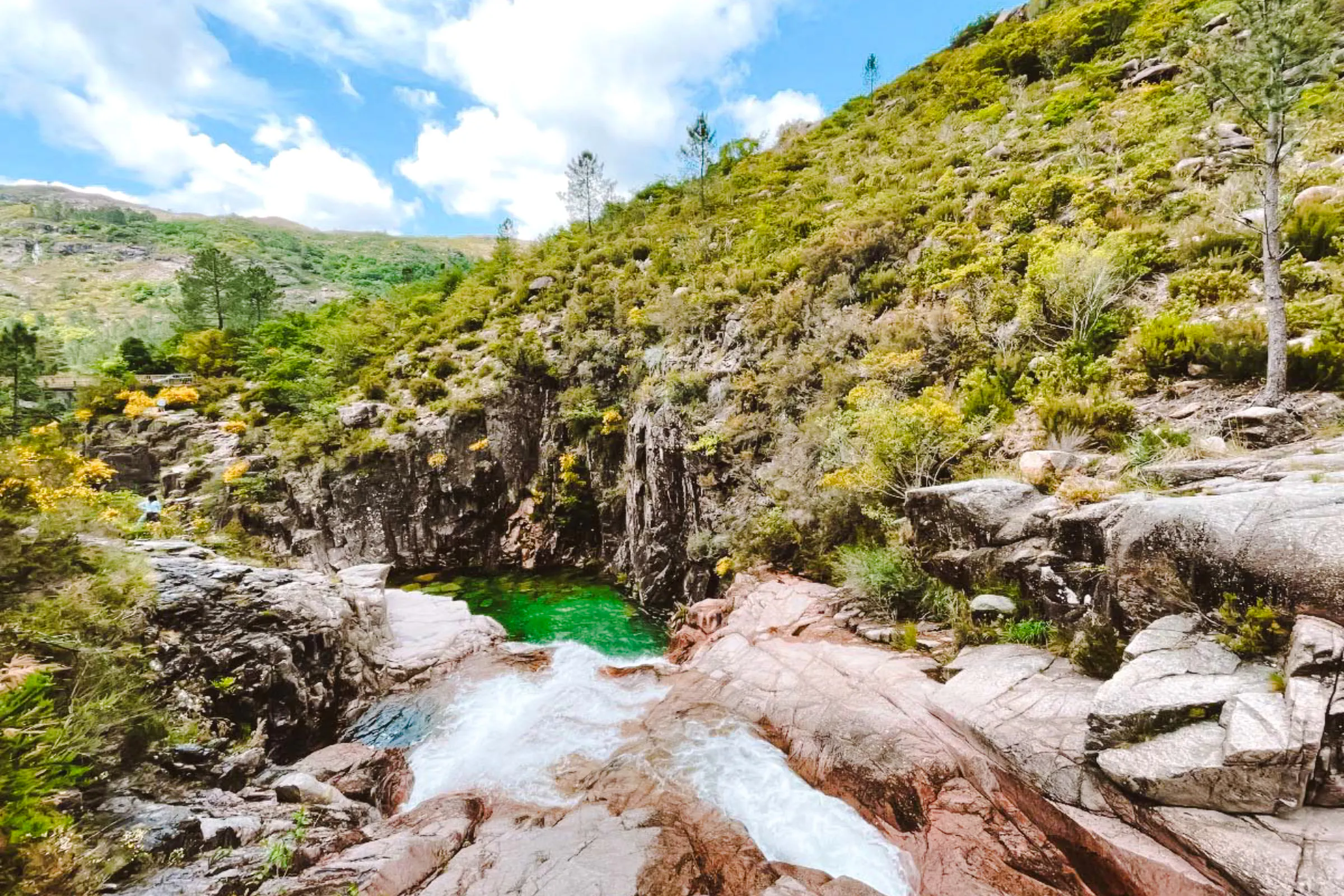 Waterfall and lush greenery in Peneda-Geres National Park, Porto hiking tour.