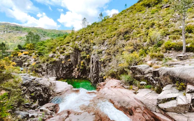 Waterfall and lush greenery in Peneda-Geres National Park, Porto hiking tour.