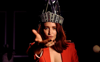 Performer in crown reaching out during Late Night Vice show in Brisbane.