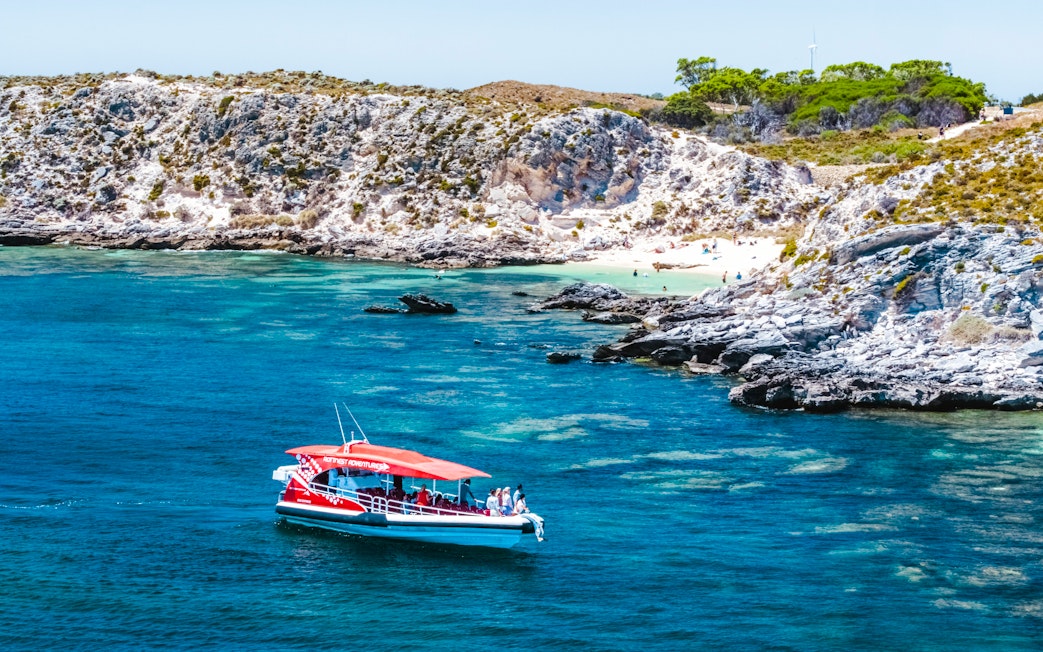 Snorkel tour boat near rocky coastline and beach, Perth/Fremantle.