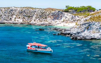 Snorkel tour boat near rocky coastline and beach, Perth/Fremantle.