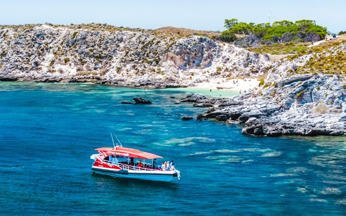 Snorkel tour boat near rocky coastline and beach, Perth/Fremantle.