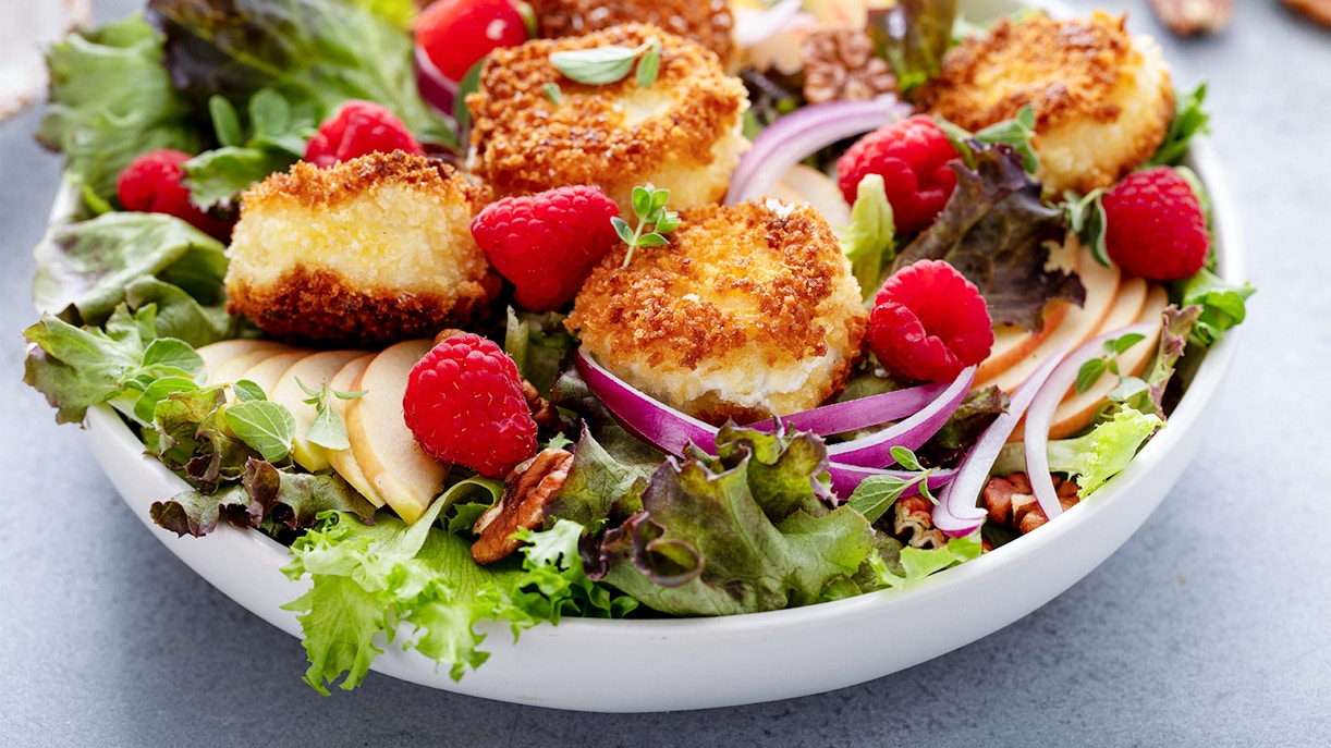 Beetroot salad with fried cheese, raspberries, and mixed greens, part of Medieval Dinner Prague menu.