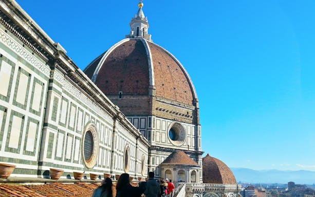 Florence Cathedral dome and terraces with visitors, Italy.