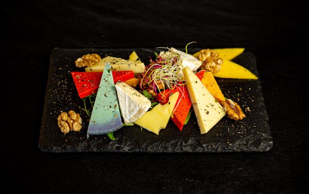 Cheese platter with assorted cheeses and walnuts on a Budapest dinner cruise.