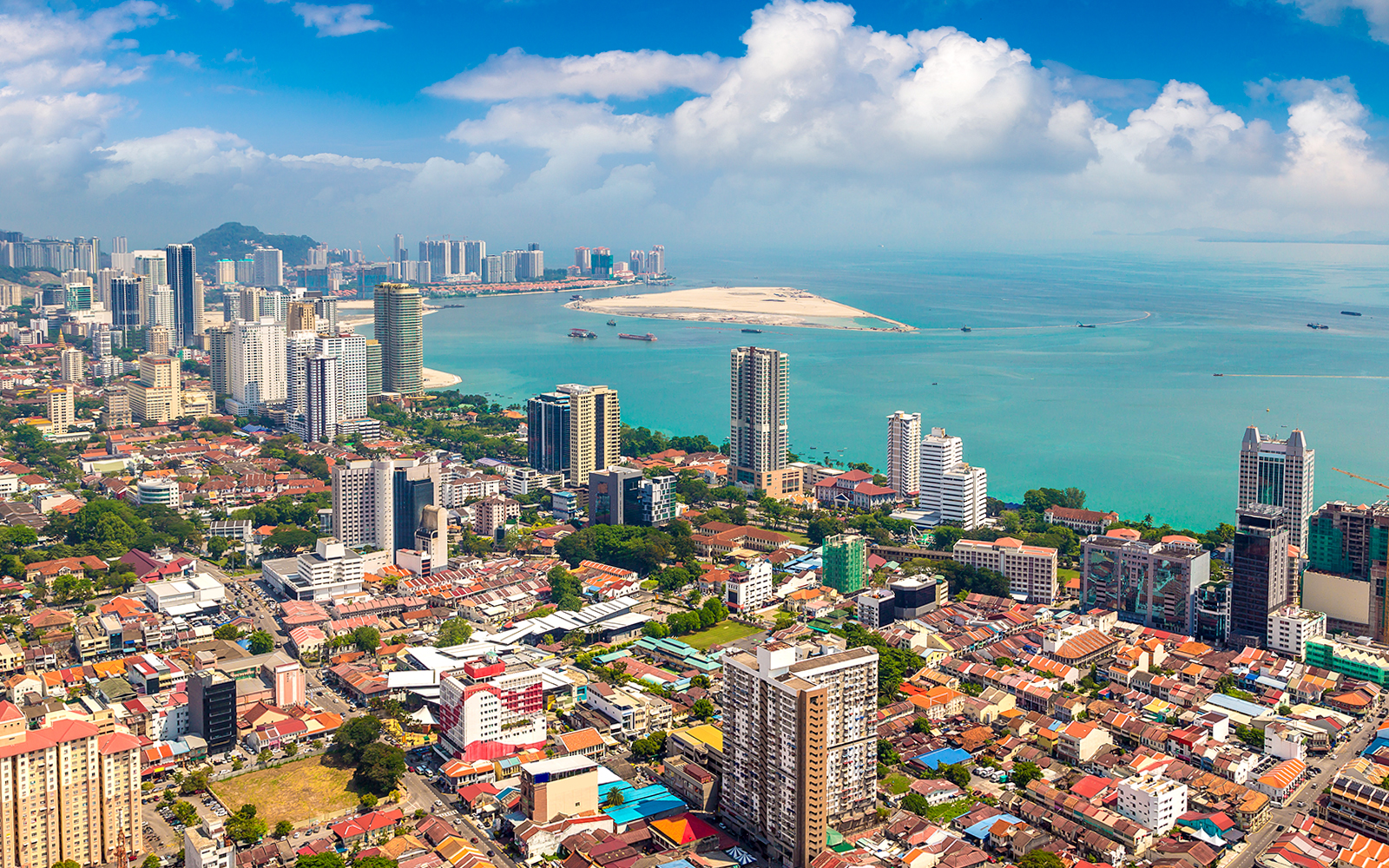 Aerial view of George Town, Penang showcasing historic buildings and coastline.