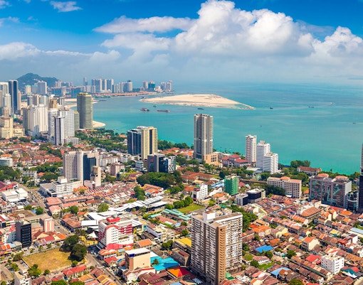 Aerial view of George Town, Penang showcasing historic buildings and coastline.