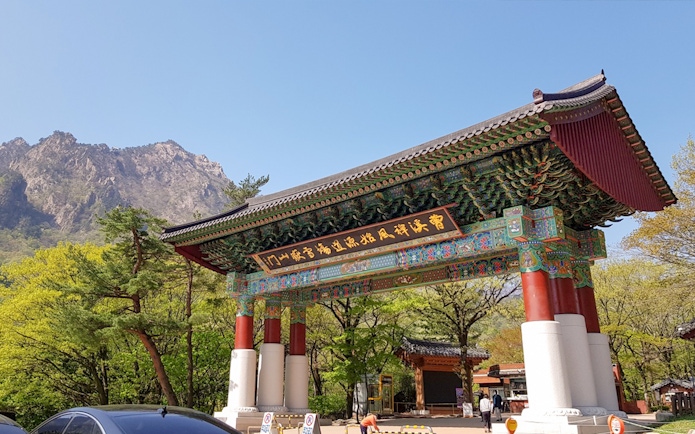 Entrance gate to Naksansa Temple with Mt. Seorak in the background, South Korea.