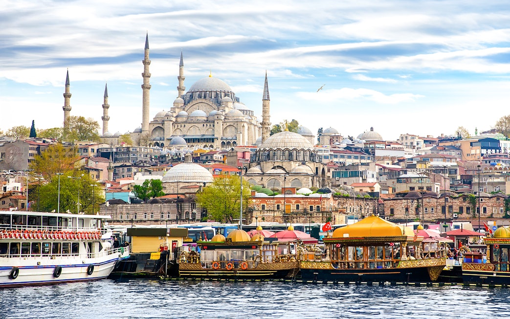 Boats on the Bosphorus with Suleymaniye Mosque in Istanbul, Turkey.