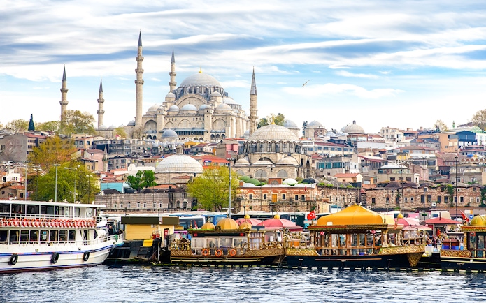 Boats on the Bosphorus with Suleymaniye Mosque in Istanbul, Turkey.