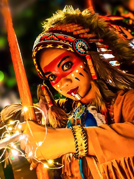 Performer in traditional costume with face paint at Sunway Lagoon Night Park.