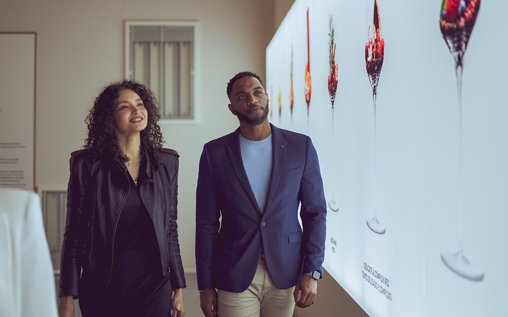 Visitors exploring wine display at The Wine Experience.
