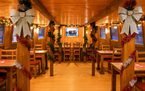 Interior of Advent Cruise in Prague decorated with festive garlands and bows.