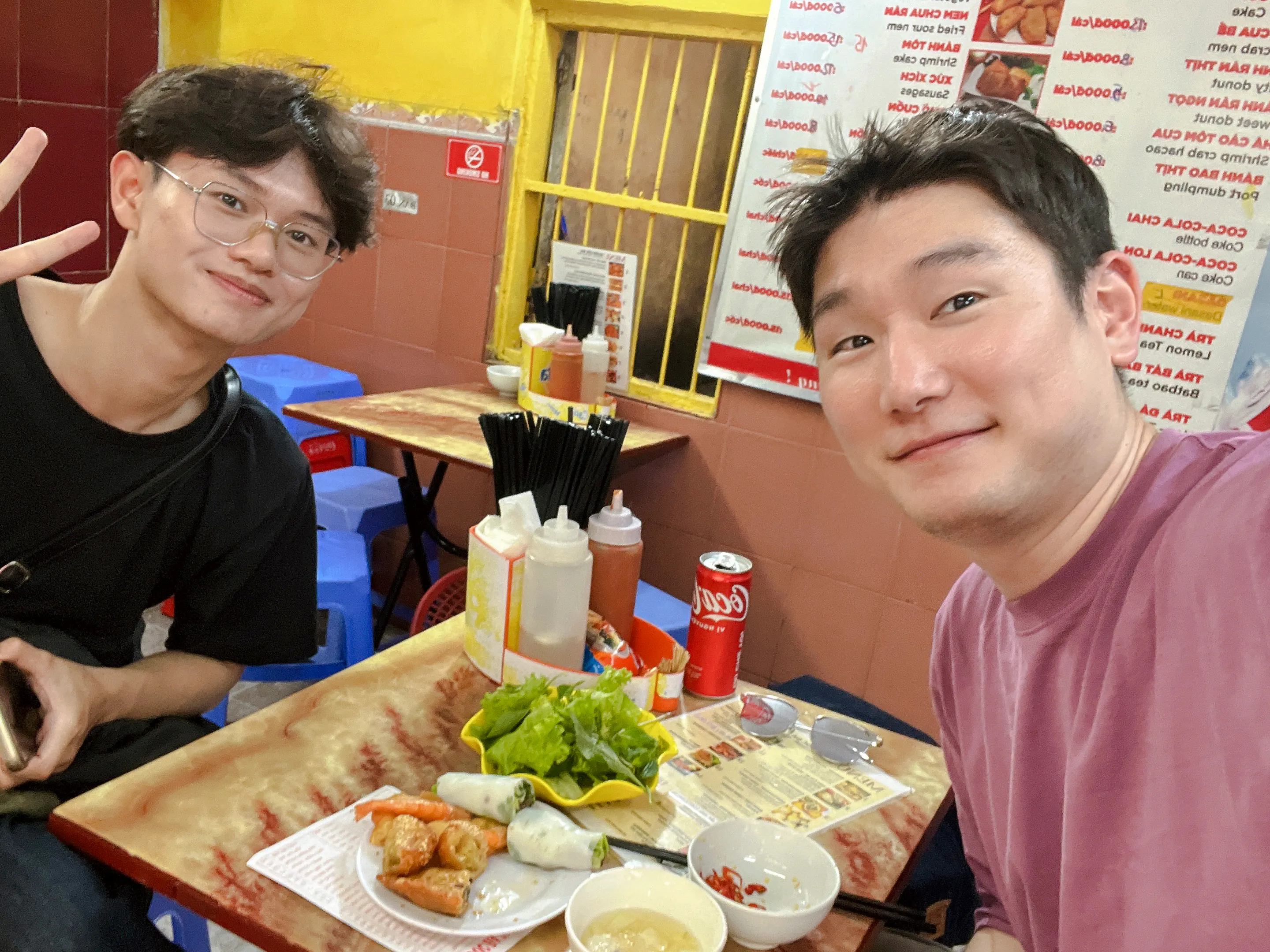 Two people enjoying a meal at a local eatery during a Hanoi street food tour.