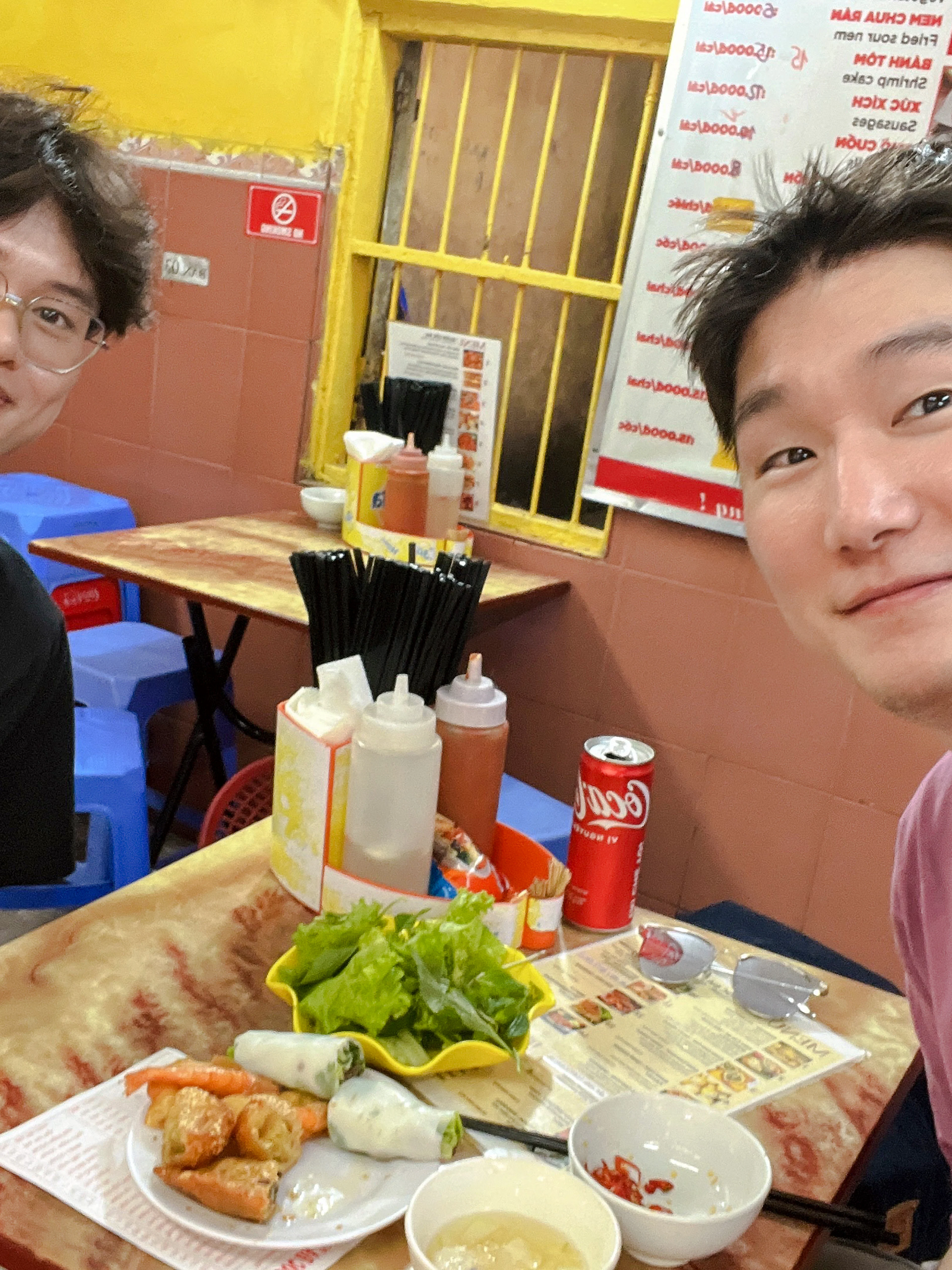 Two people enjoying a meal at a local eatery during a Hanoi street food tour.
