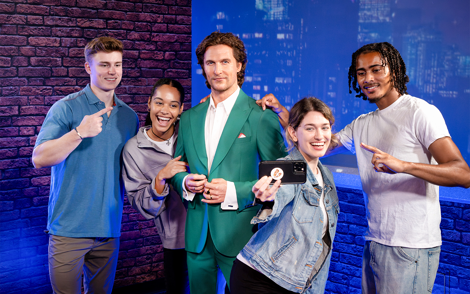 Friends posing with wax figure at Madame Tussauds, New York.
