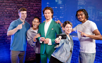 Friends posing with wax figure at Madame Tussauds, New York.