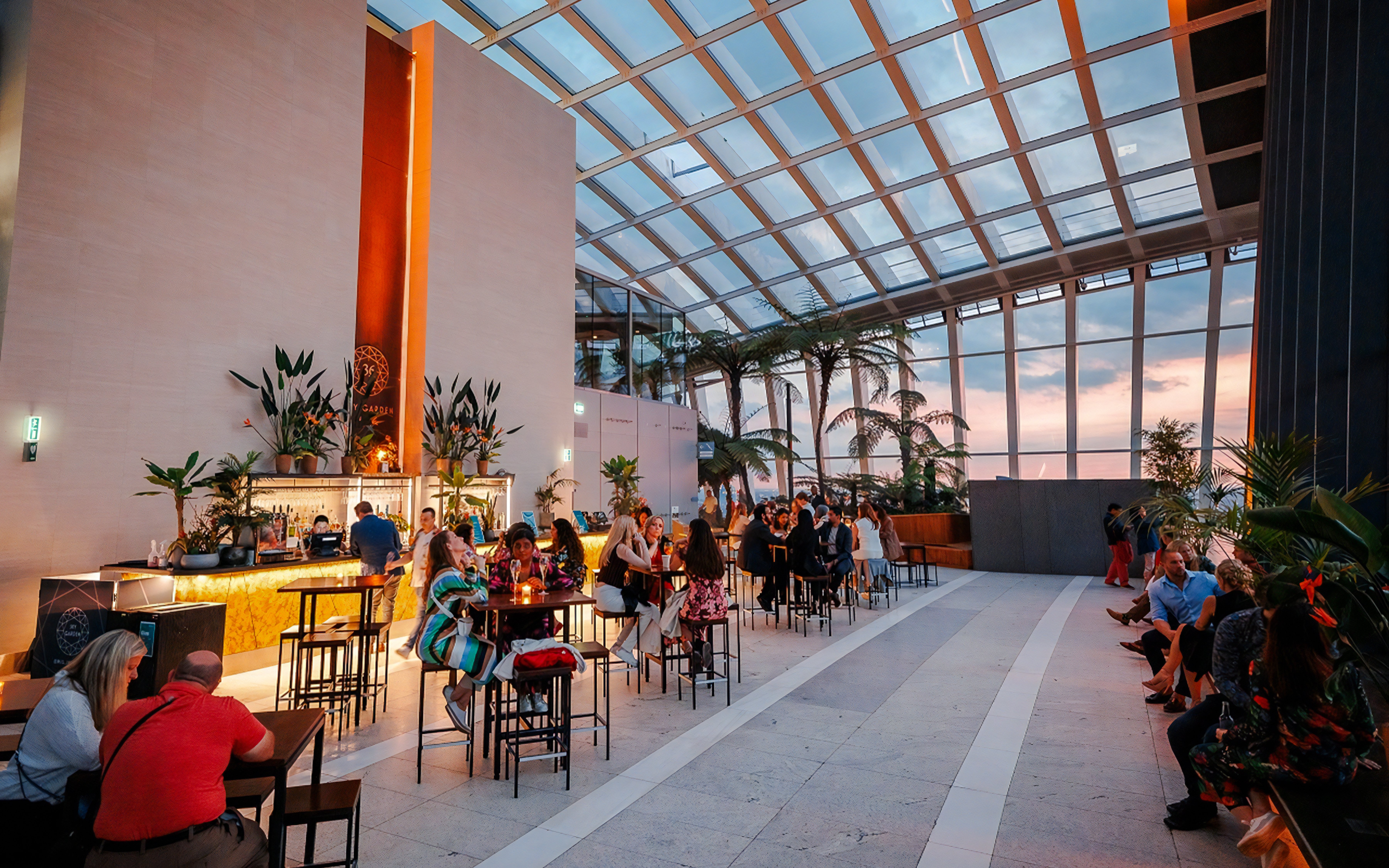 Guests enjoying Music Night at Sky Garden with sunset views.